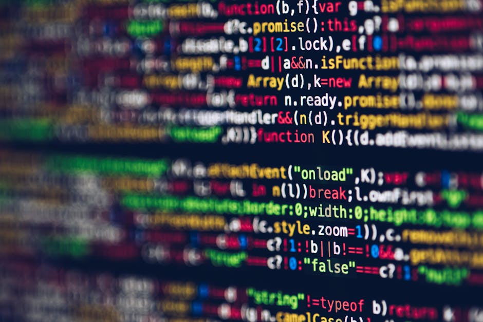 A close-up view of a computer screen displaying lines of colorful programming code in various shades such as red, green, blue, yellow, and pink, with each line containing different syntax elements, ke